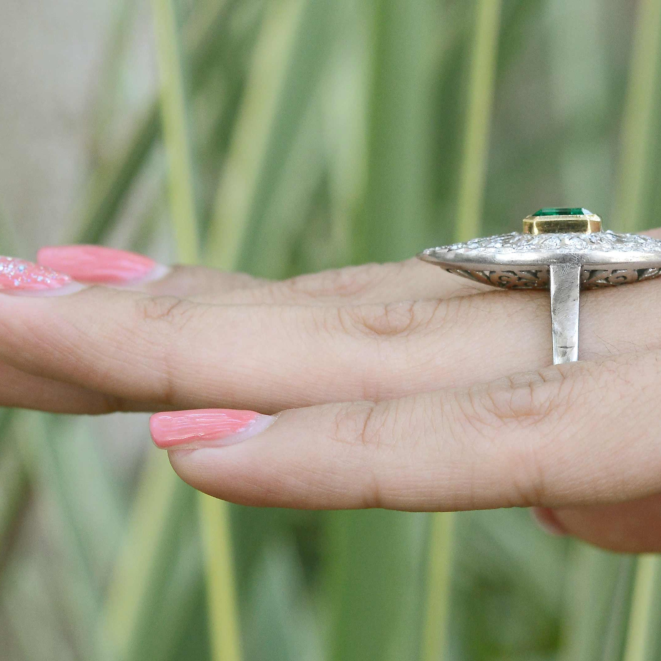 A long navette shaped, 2 tone emerald and diamonds cocktail ring.