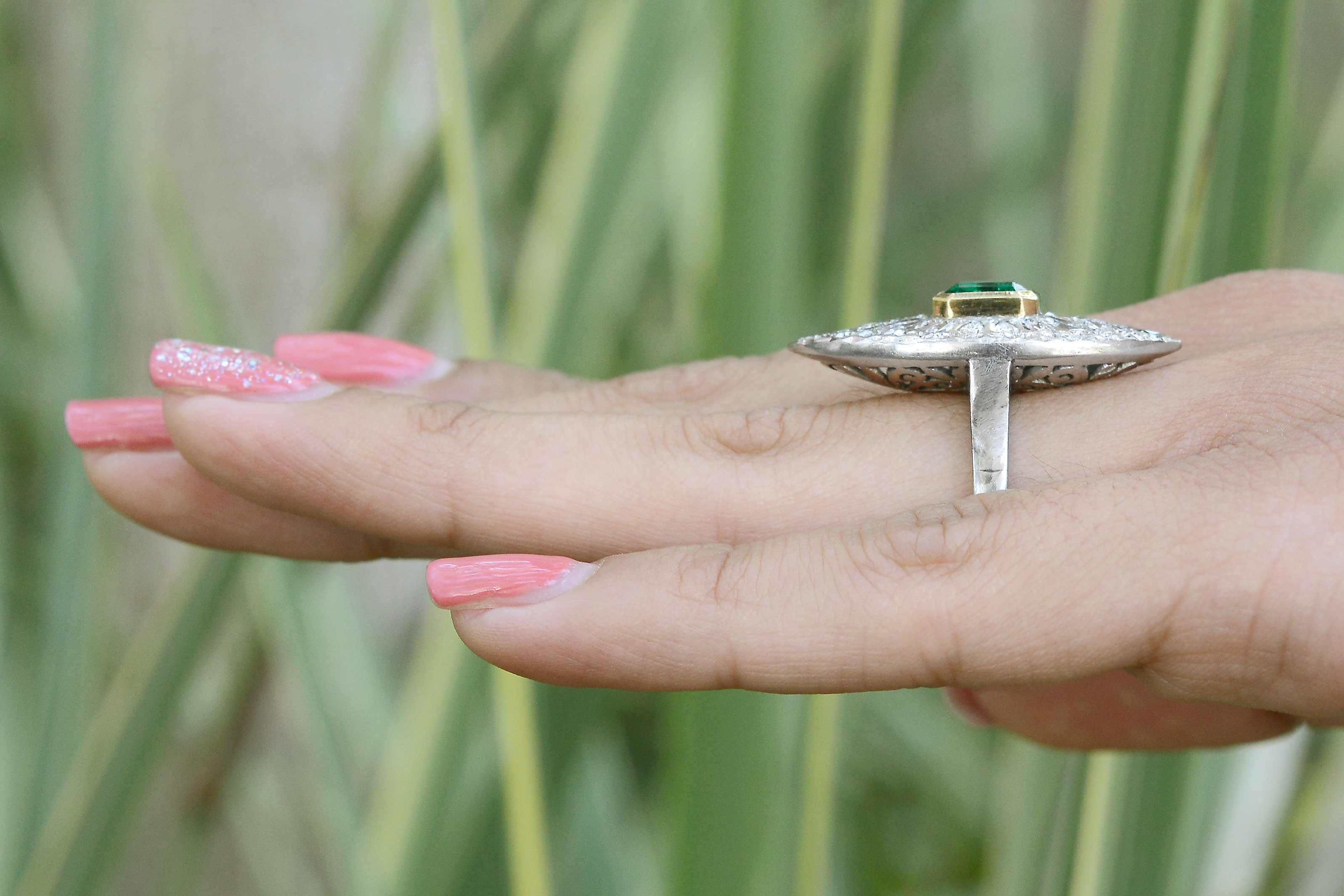 A long navette shaped, 2 tone emerald and diamonds cocktail ring.