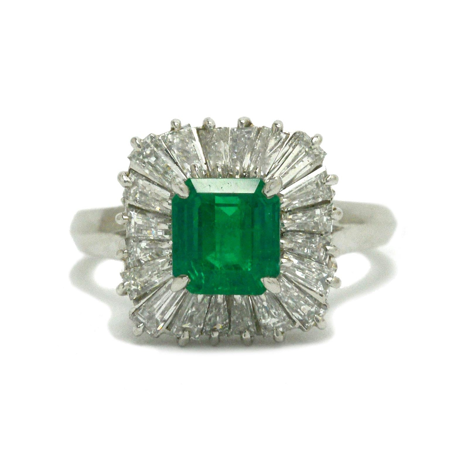 A mid-century 1960s emerald target ring, surrounded by diamonds.