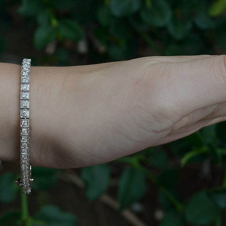 Two carats of diamonds are set in a straight line in this white gold tennis bracelet.