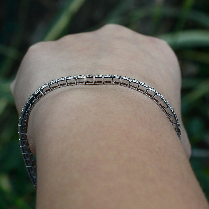 Square filigree links hold 2 carats of round brilliant diamonds.