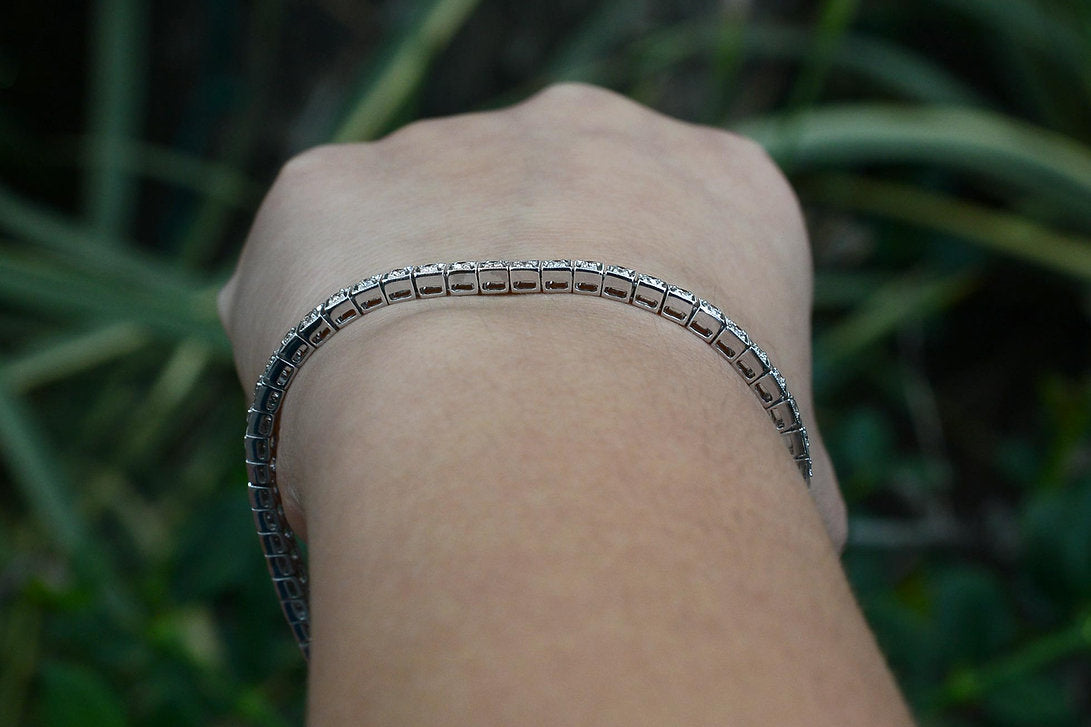 Square filigree links hold 2 carats of round brilliant diamonds.