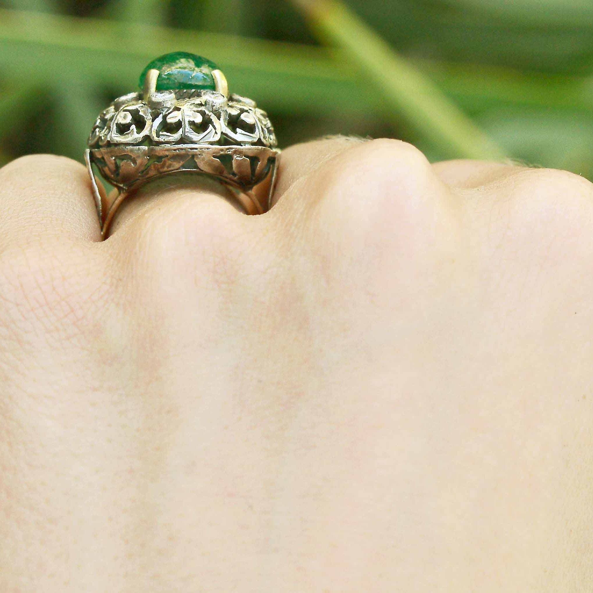A tall, 3 carat oval cabochon emerald set in a Victorian statement ring.