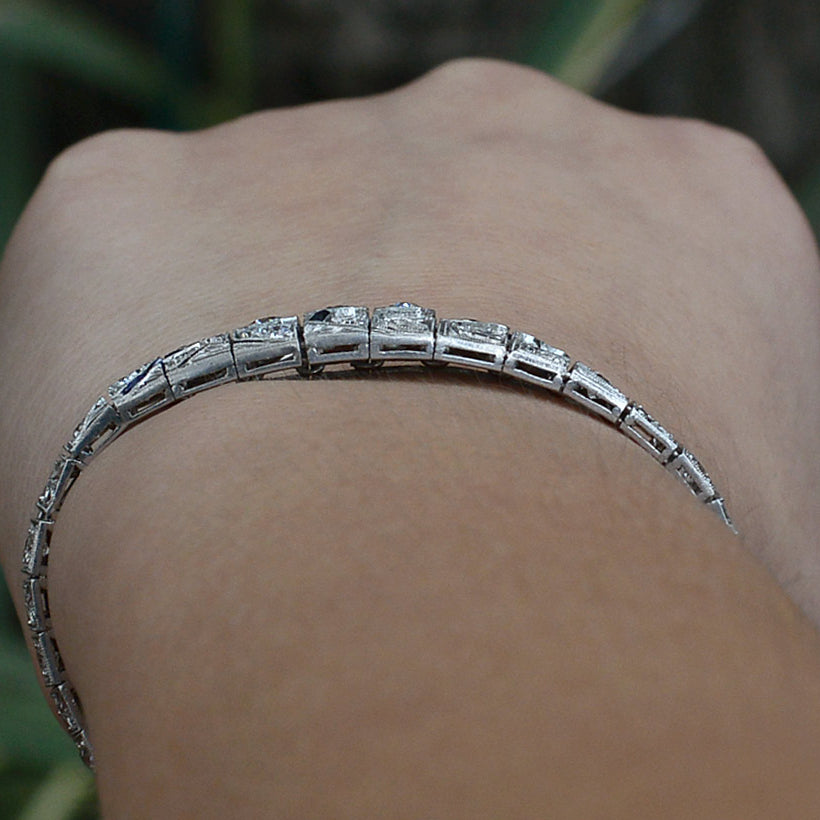 A tapered platinum diamonds bracelet.