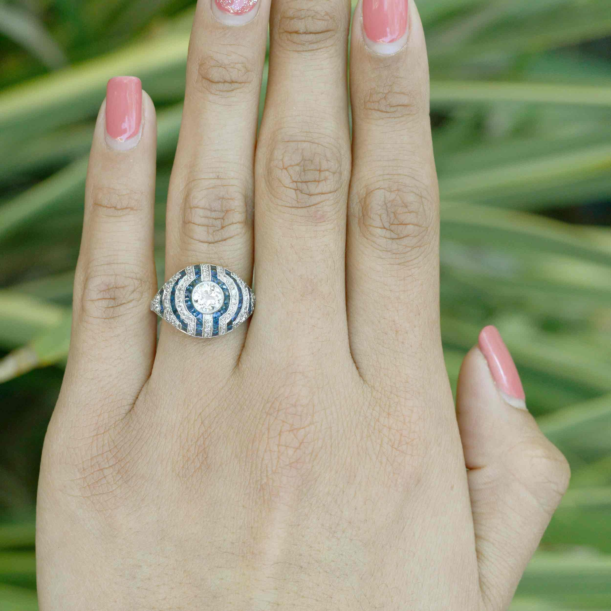 The lines of diamonds and blue sapphires make a unique pattern in this engagement ring.