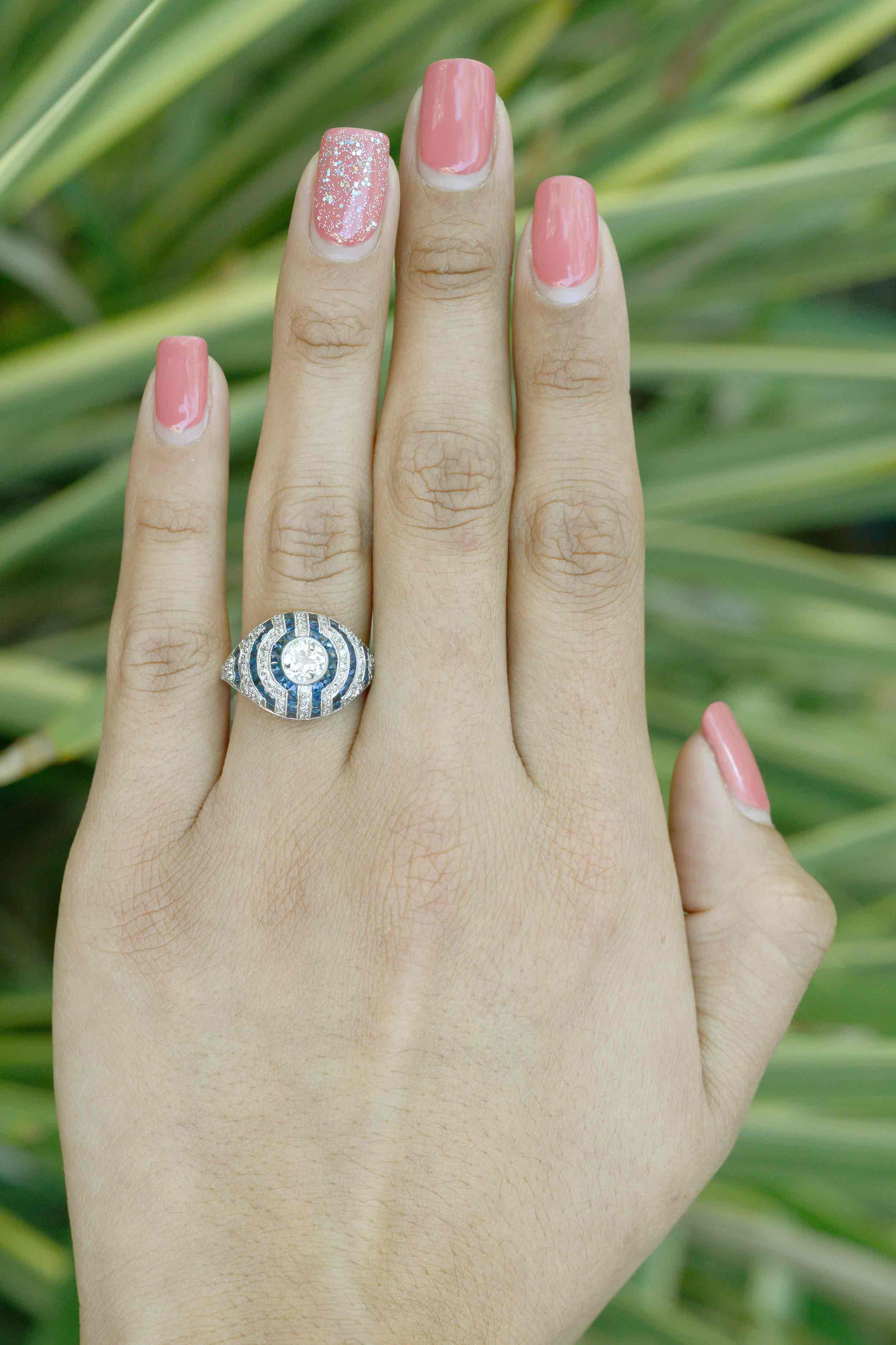 The lines of diamonds and blue sapphires make a unique pattern in this engagement ring.