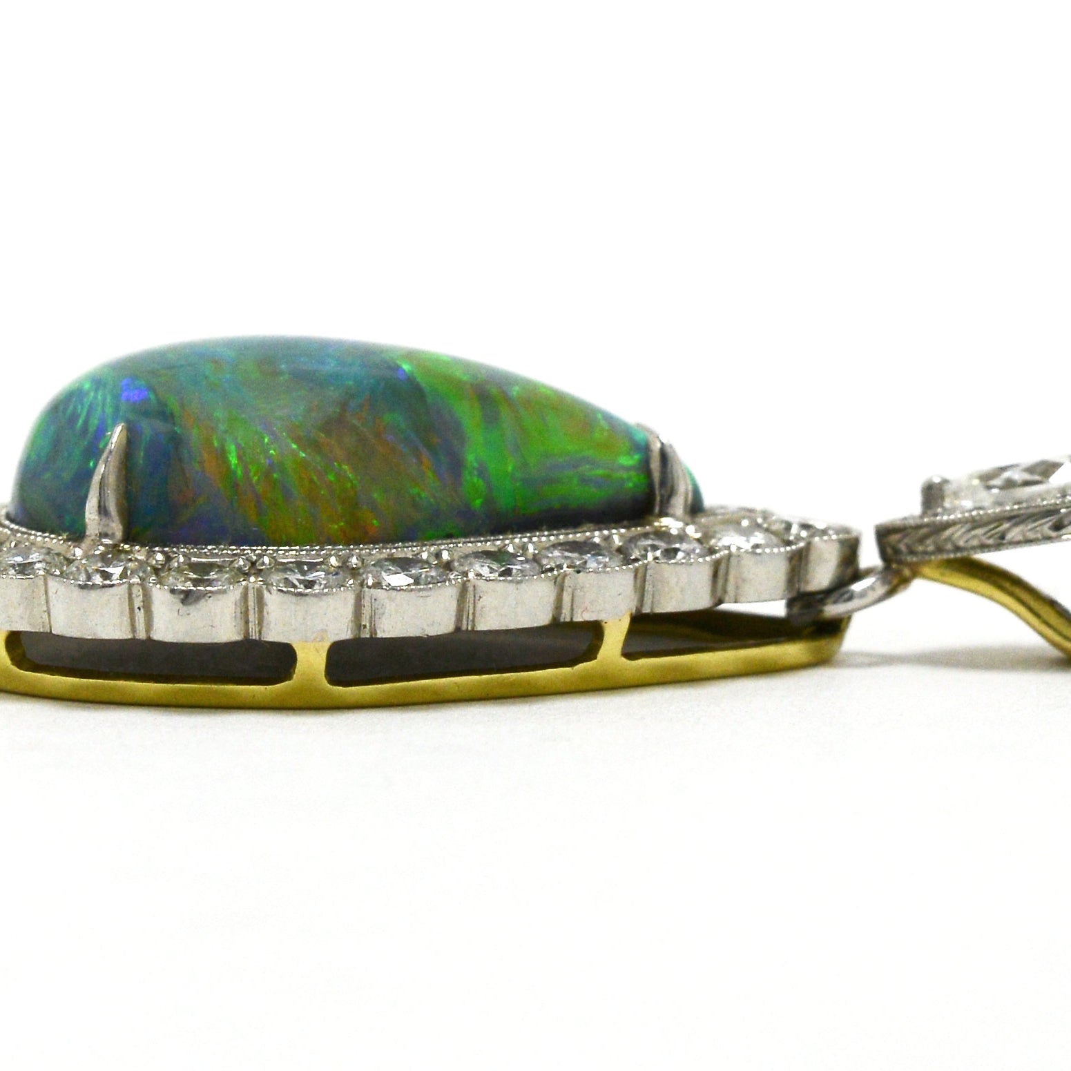 A platinum and gold cabochon black opal necklace with diamonds.