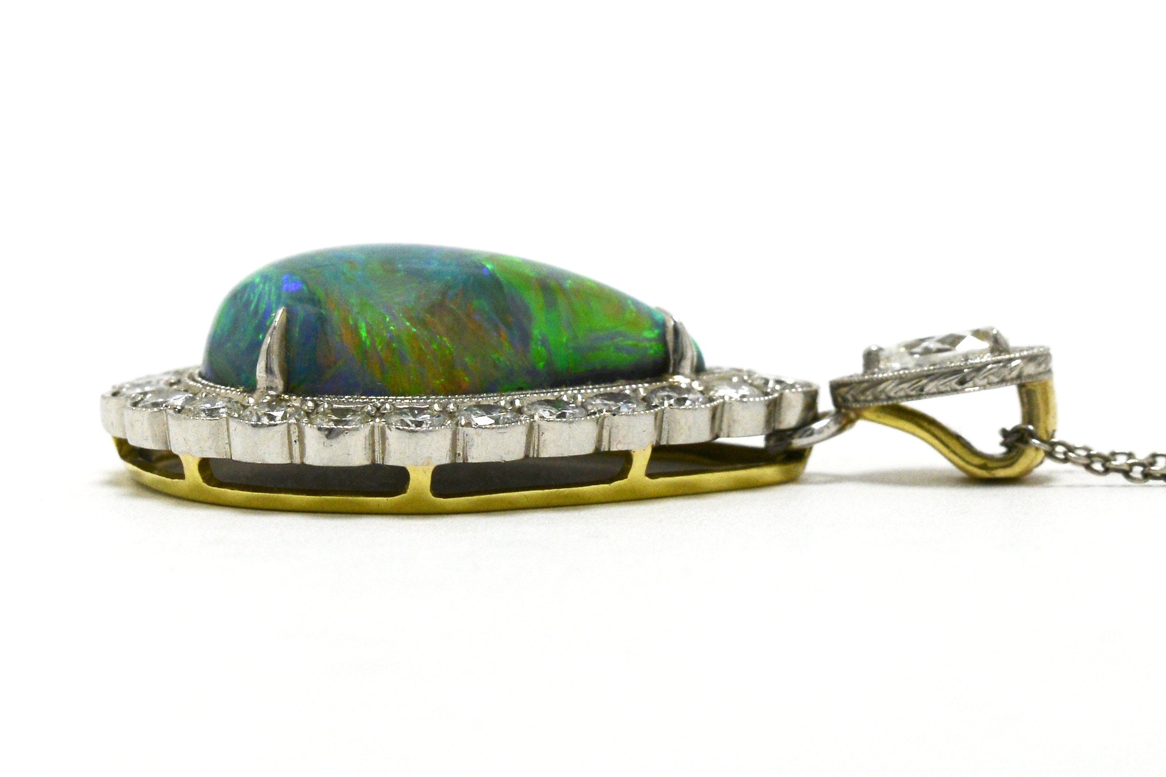 A platinum and gold cabochon black opal necklace with diamonds.