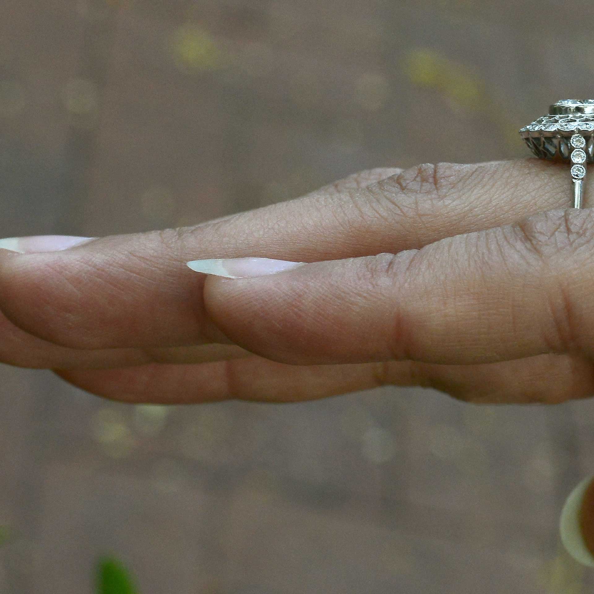An Edwardian style laced halo diamond engagement ring.