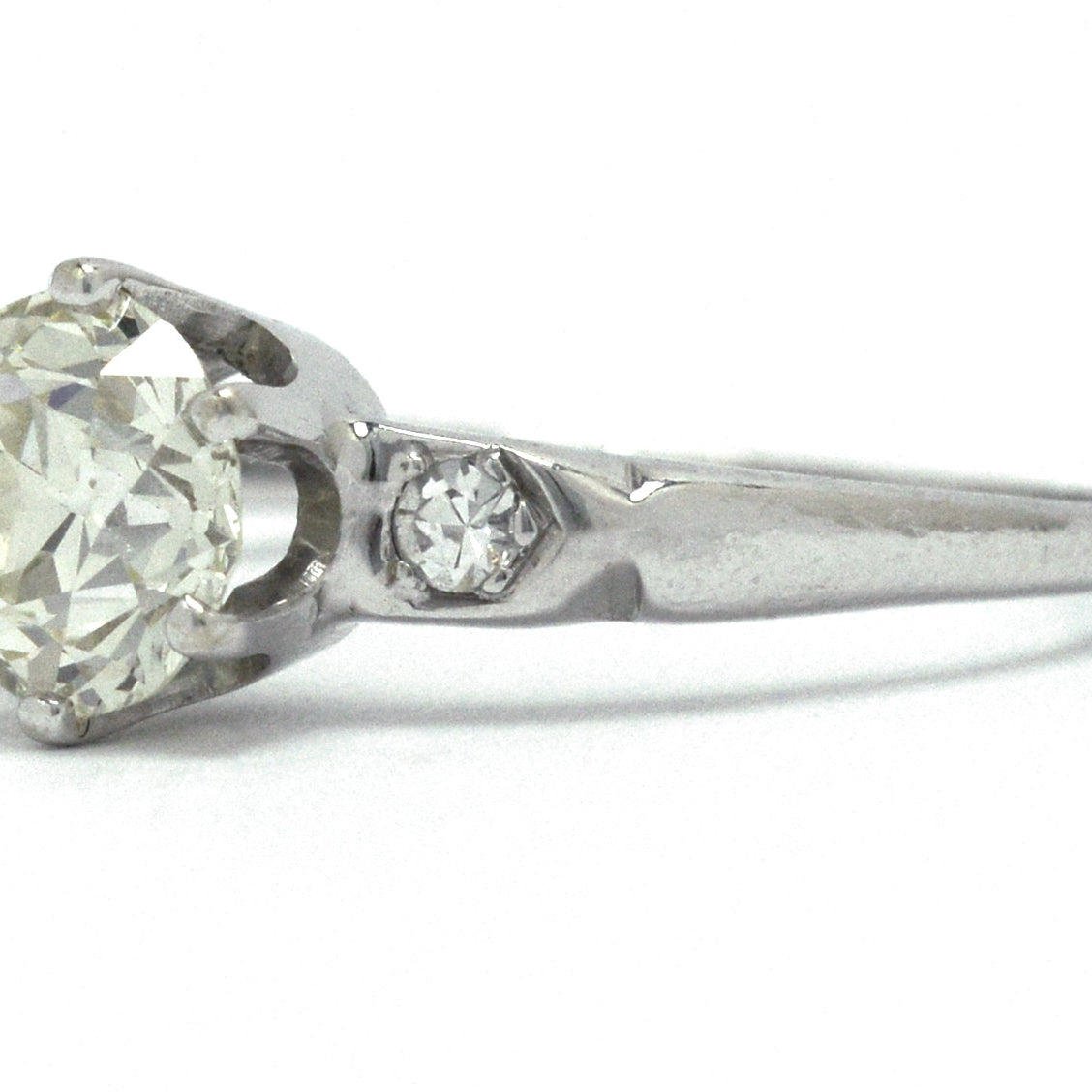A Tiffany style solitaire engagement ring with a slightly yellow diamond.
