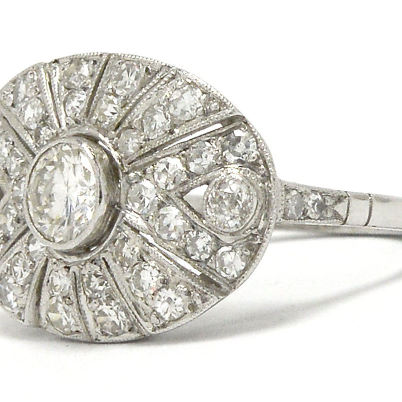 A radiating diamonds, oval shaped platinum antique statement ring.