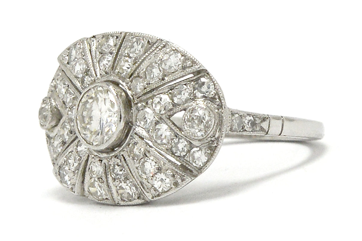 A radiating diamonds, oval shaped platinum antique statement ring.