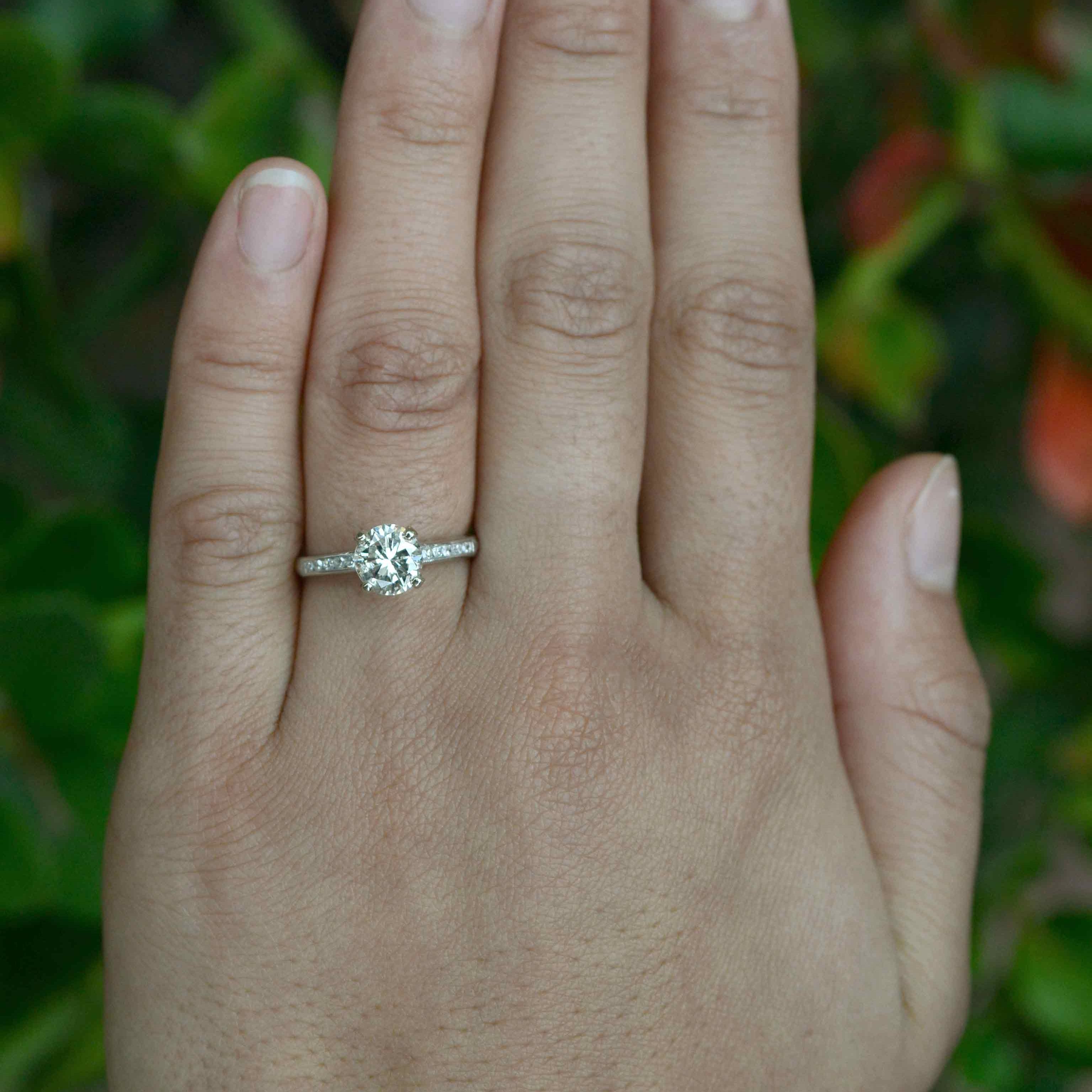 A transitional round brilliant cut diamond solitaire wedding ring.