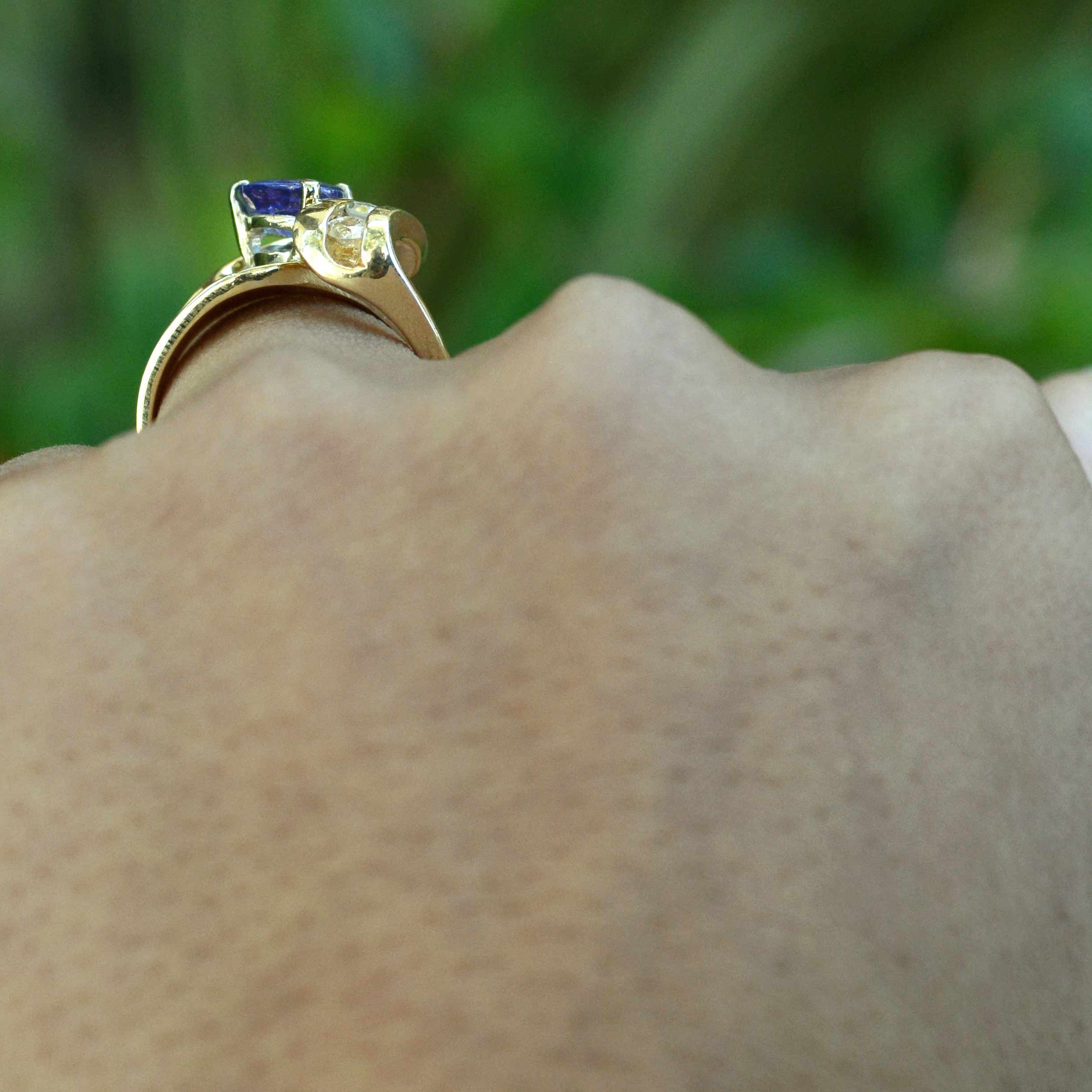 A triangle shaped tanzanite, set in a 14k gold diamonds cocktail ring.