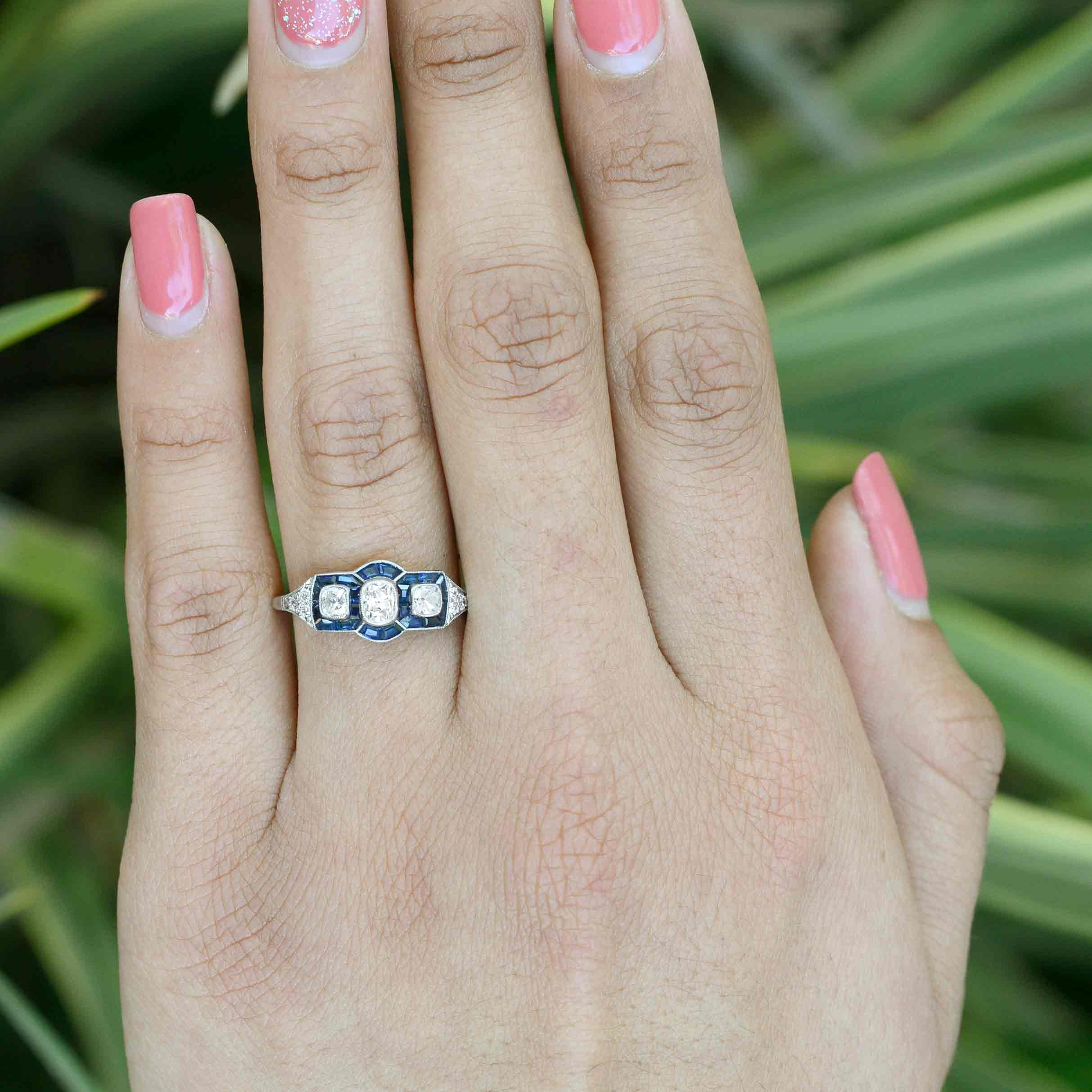 A 3 stone Art Deco diamonds and blue sapphires engagement ring.