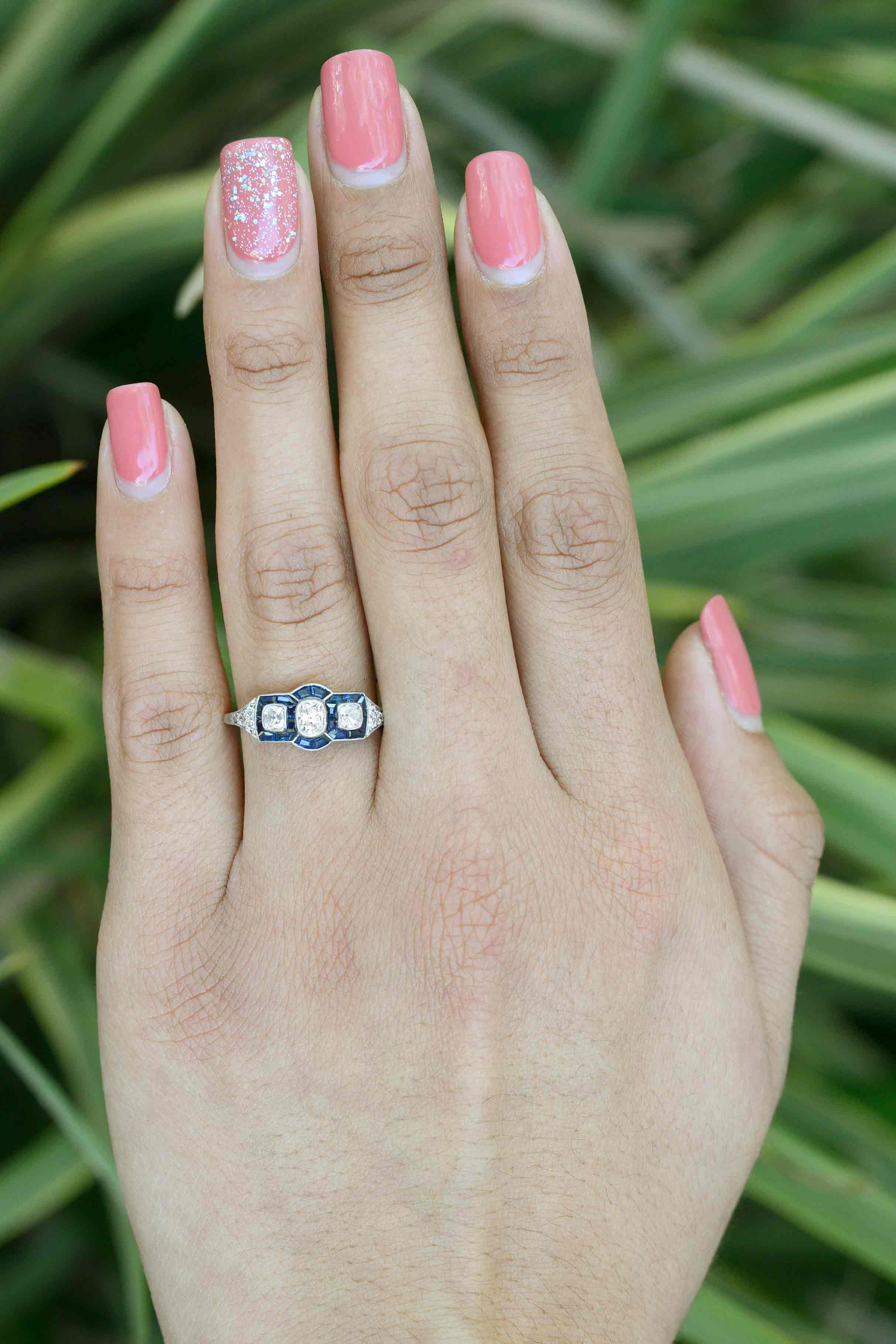 A 3 stone Art Deco diamonds and blue sapphires engagement ring.