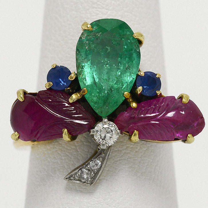 A clover ring with diamonds, rubies, emeralds and blue sapphires.