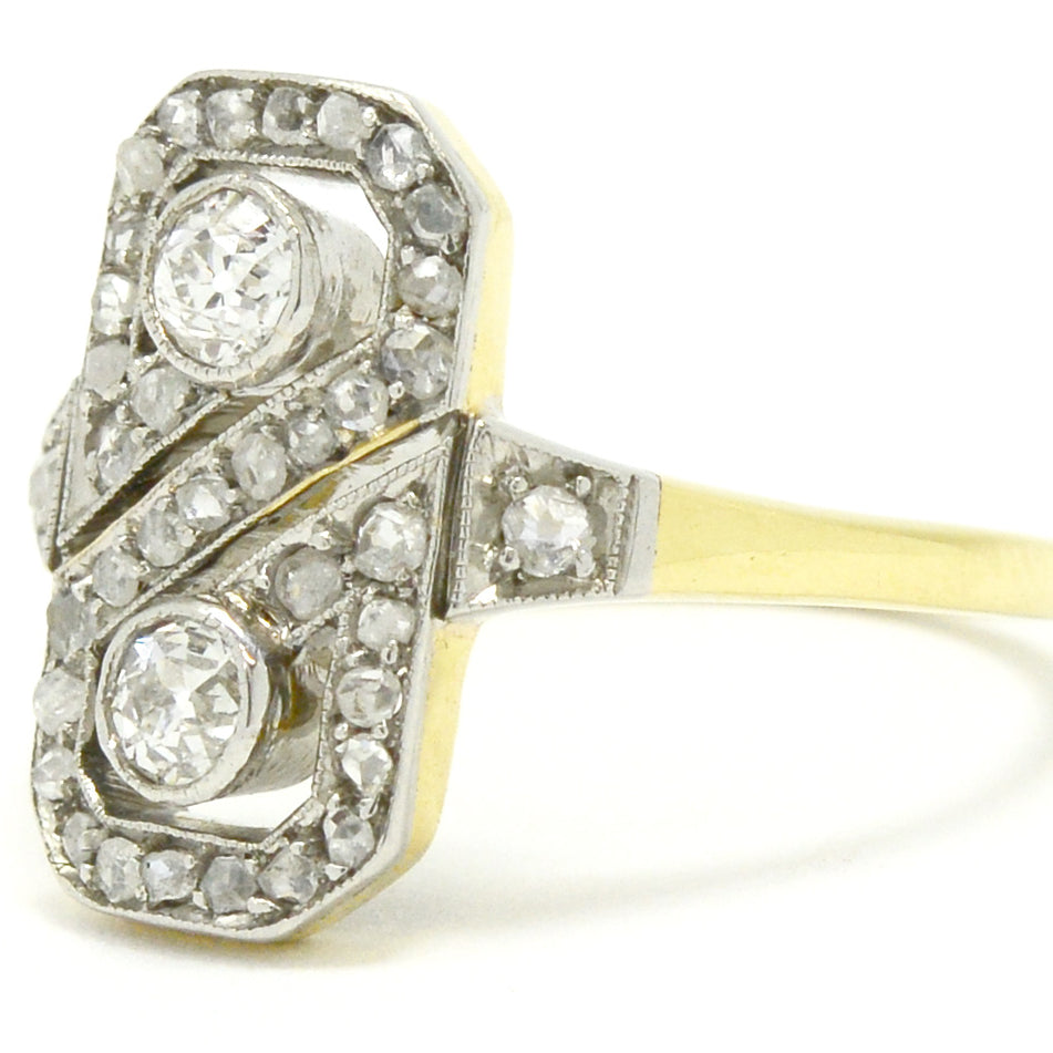 A platinum and gold 2 diamond figure 8 wedding ring design.