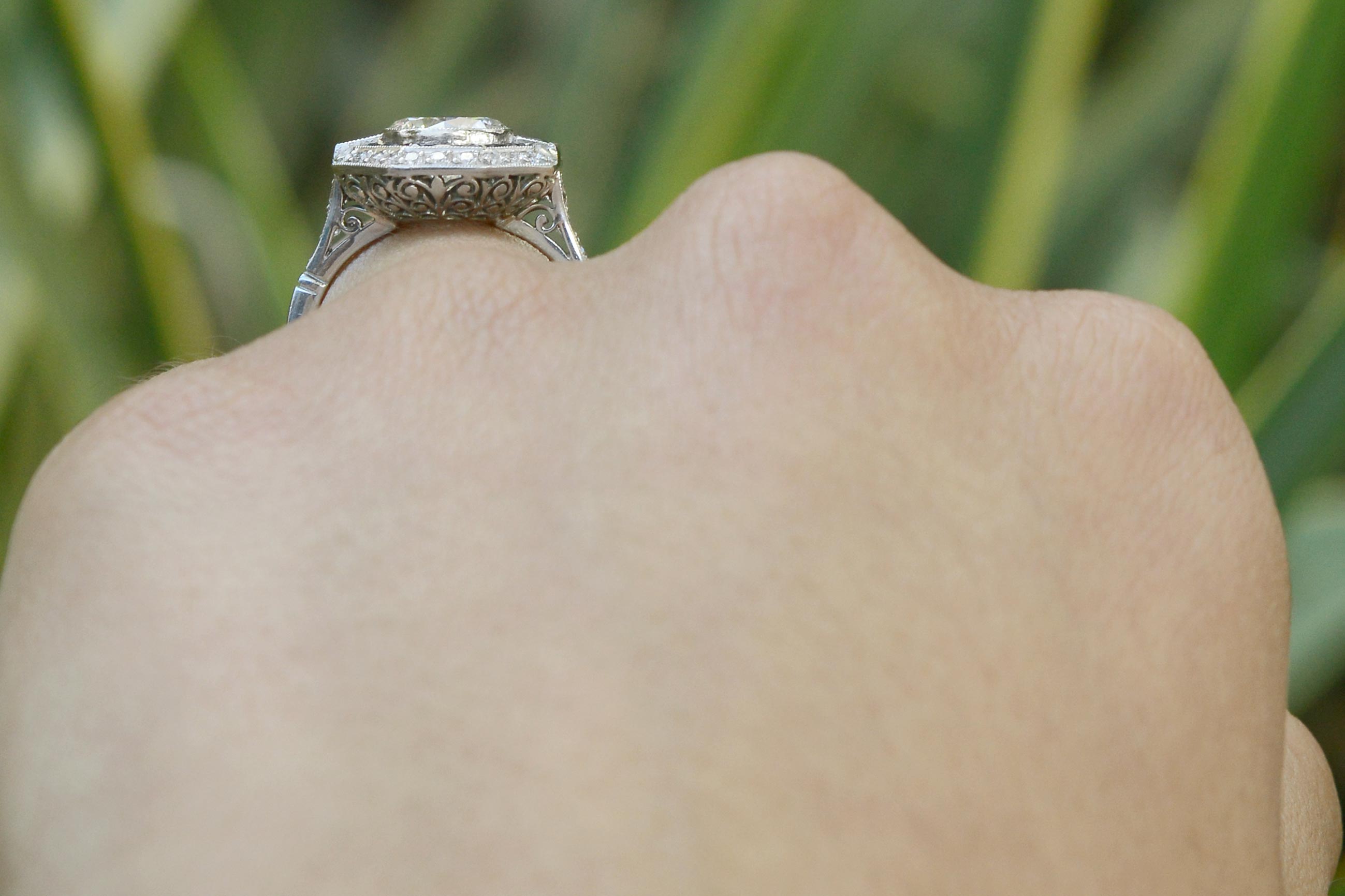 Fleur di lis filigree is shown on the underside of this stunning engagement ring.