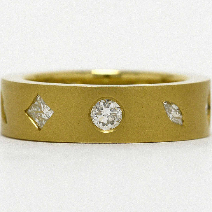 A modern anniverary band with marquise and princess cut diamonds.