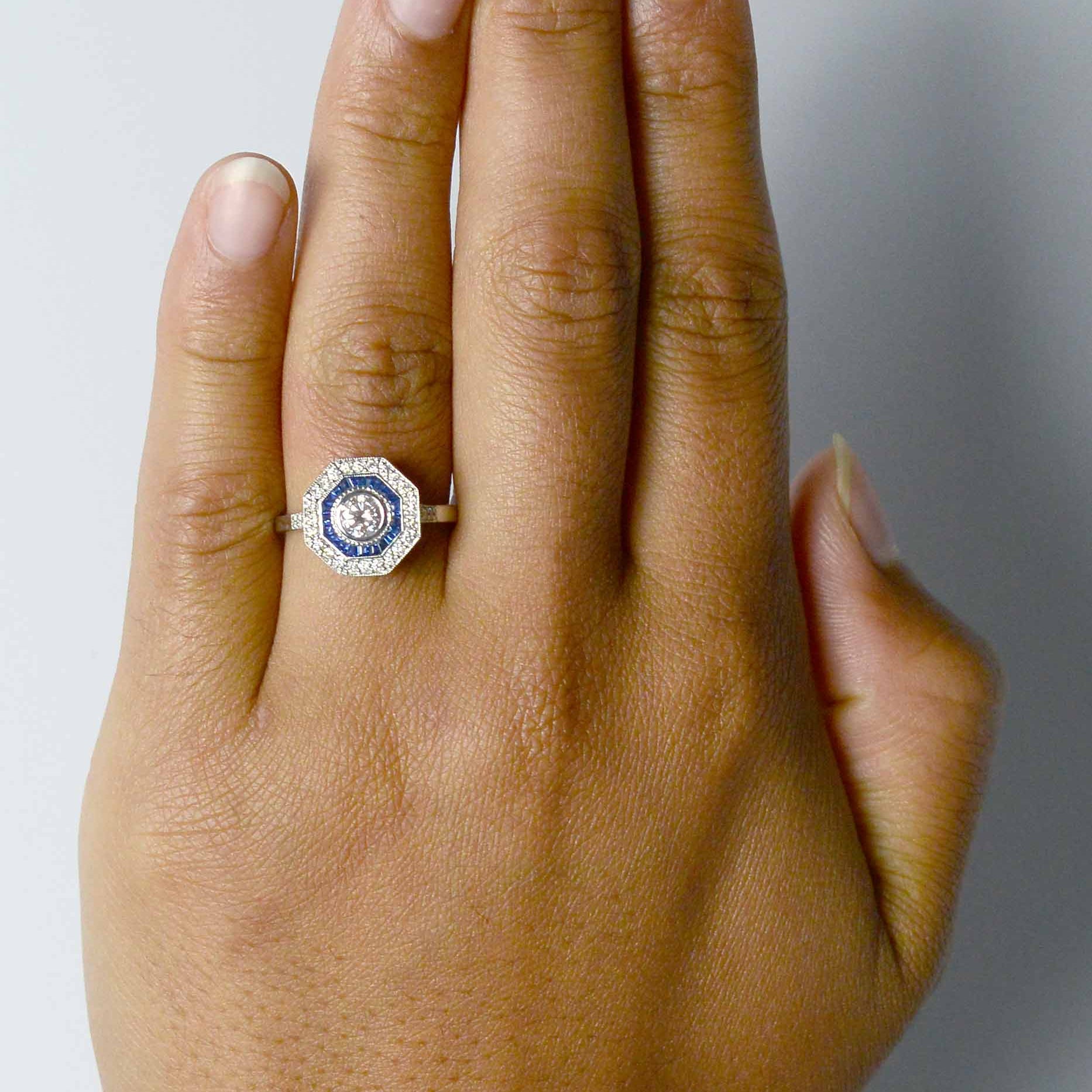 Diamond engagement ring with a pink tone.