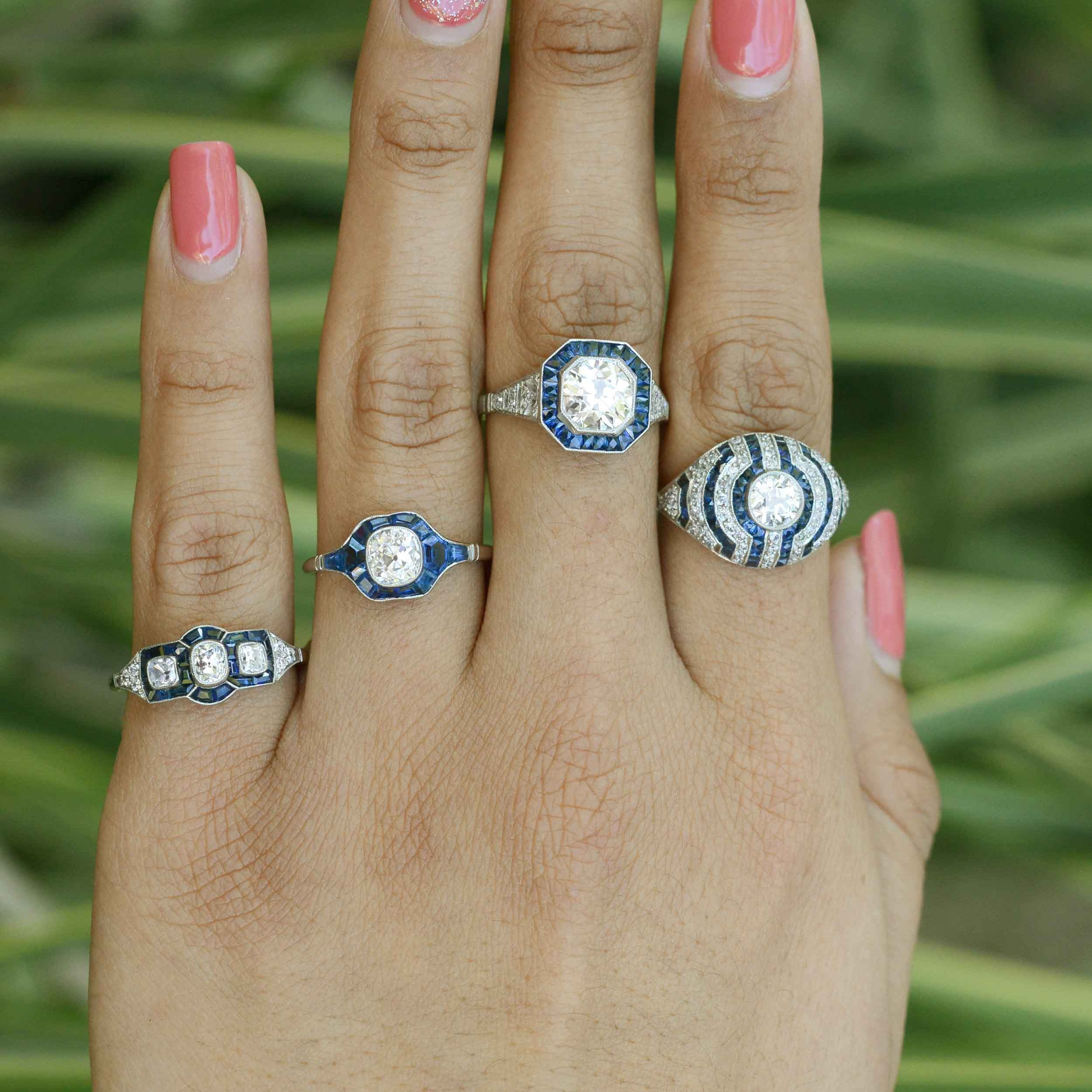Some of our diamond and blue sapphire platinum cluster engagement rings.