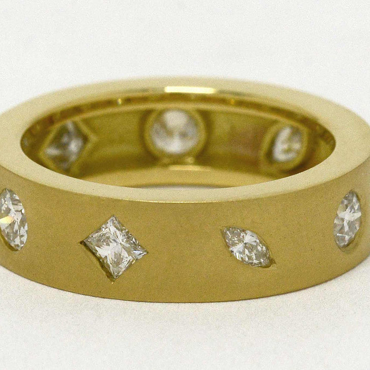 Marquise, princess and round cut diamonds in a modern comfort fit band.