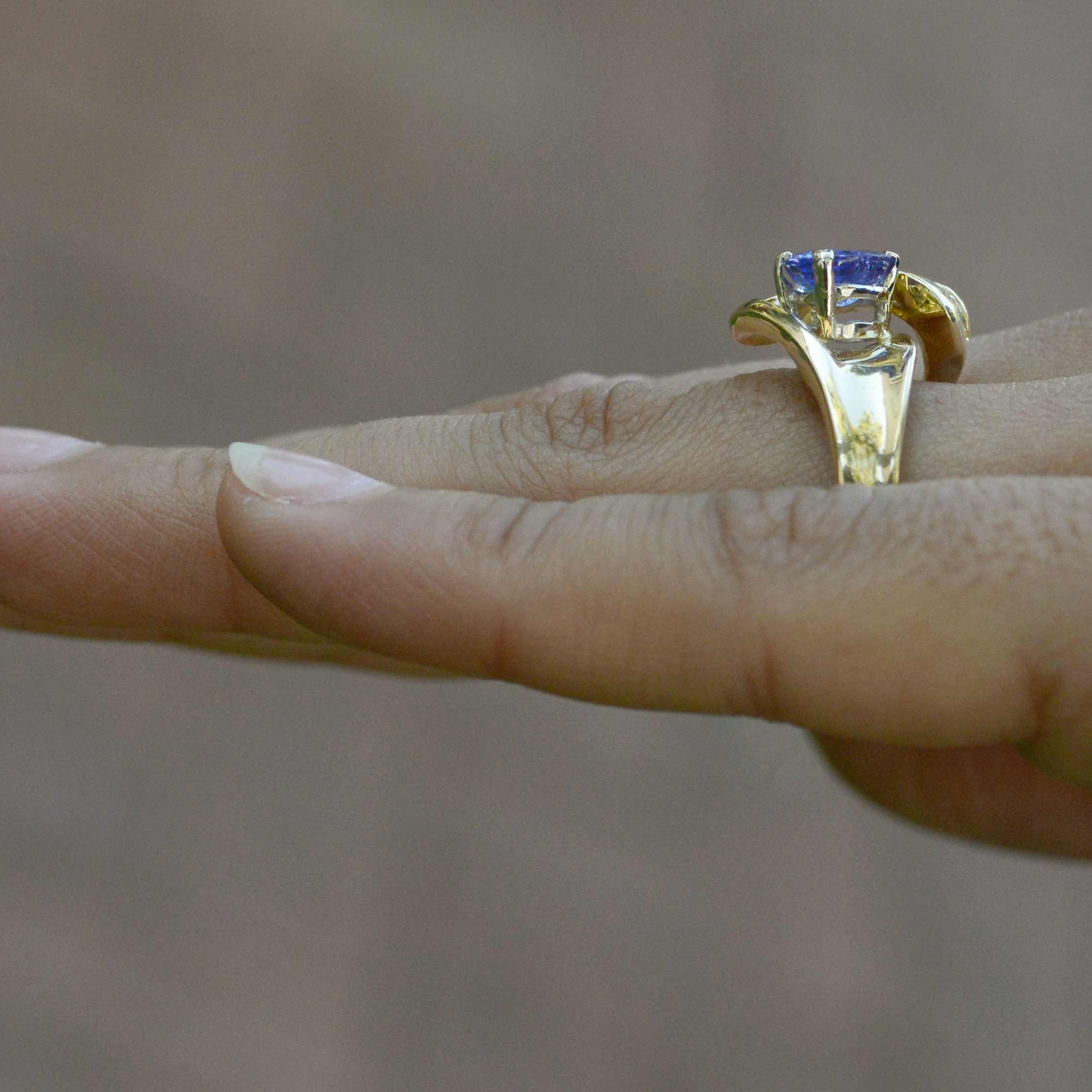 A violet blue tanzaite with good color saturation, set in a contemporary gold ring.