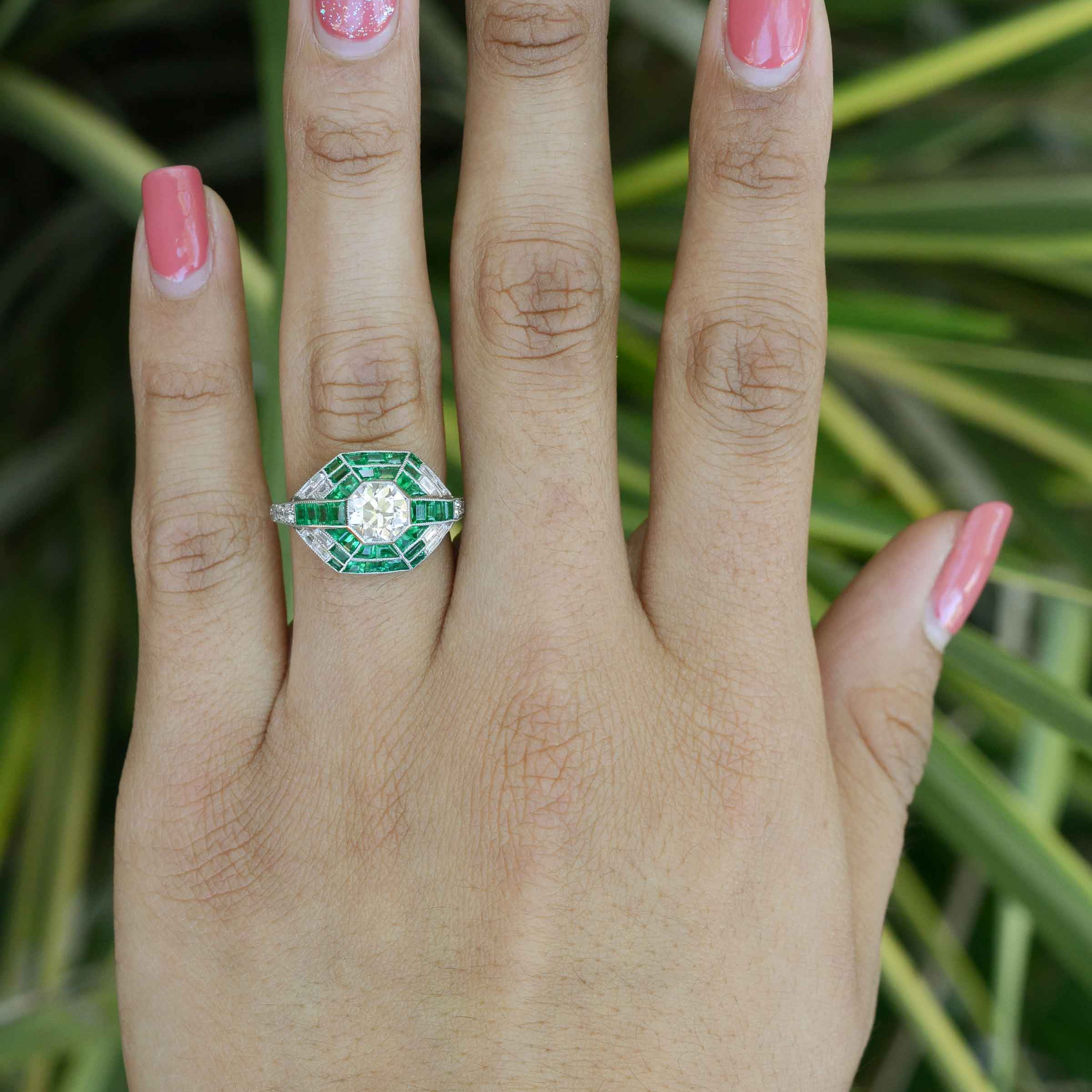 A size 6 old mine diamond engagement ring with French & calibre cut emeralds.