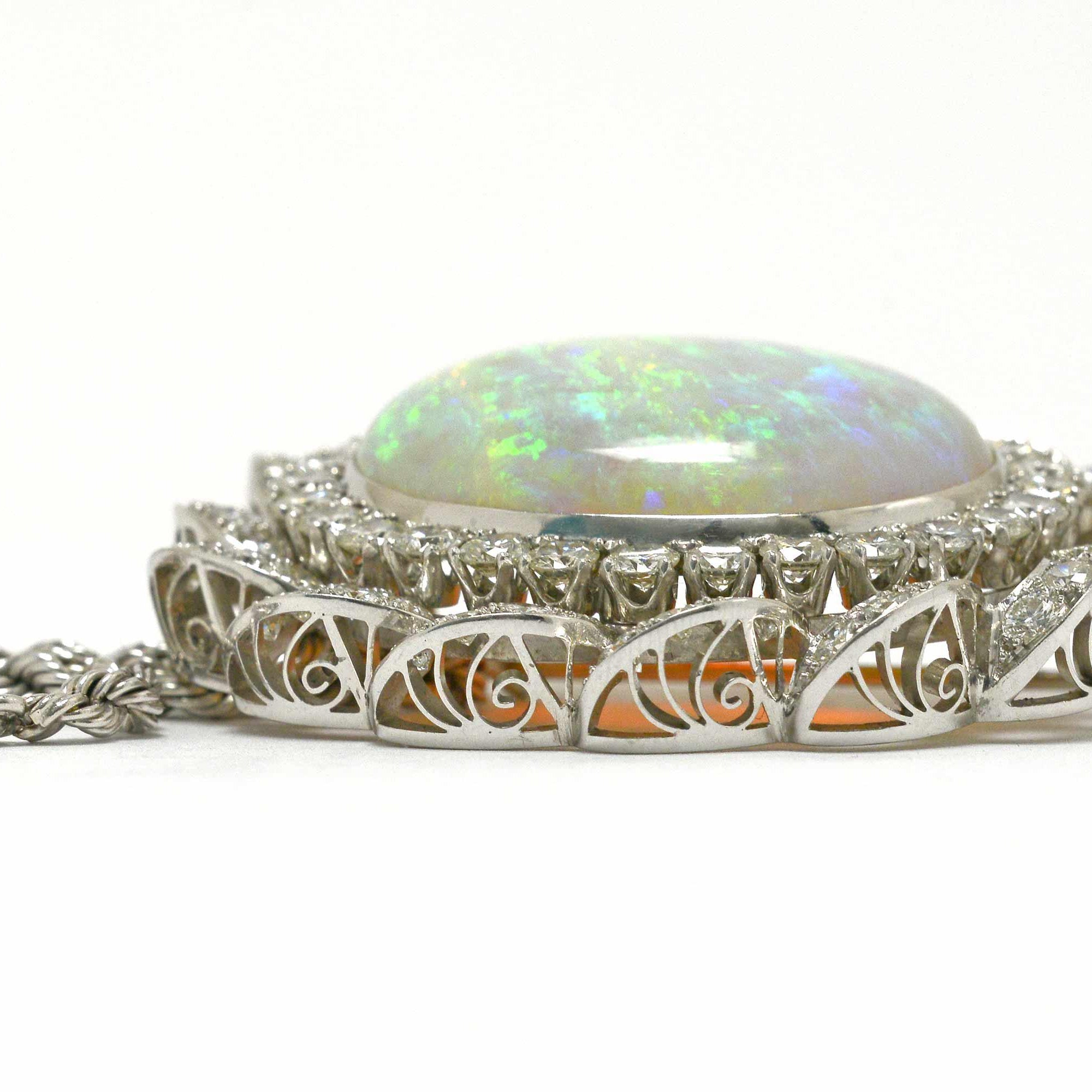 A 14k white gold 1960's diamond opal pendant necklace.