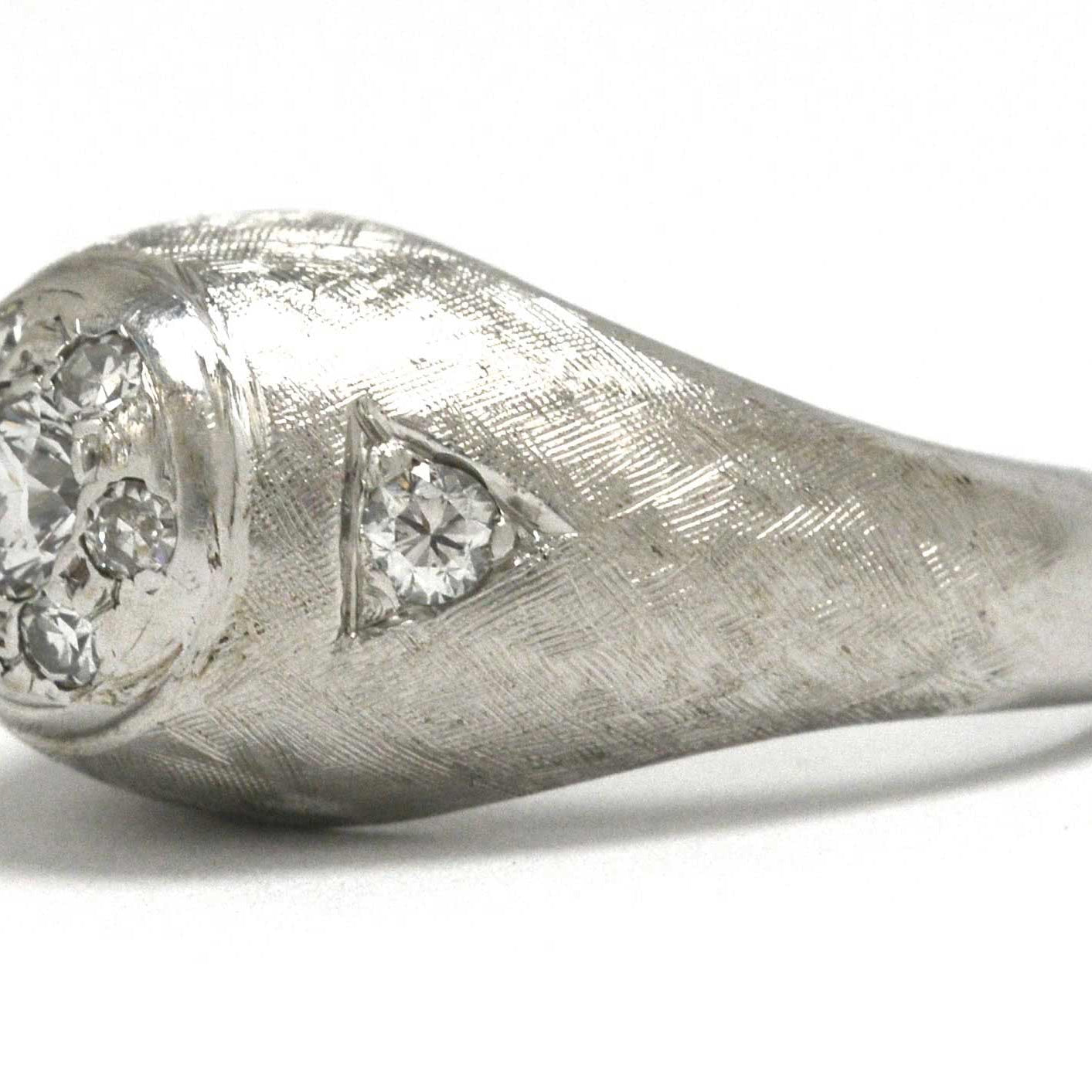 A men's white gold diamond gypsy ring with a brushed texture.