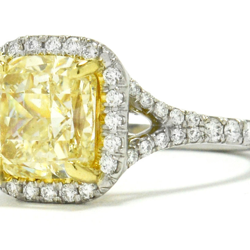 This excellently proportioned cushion cut yellow diamond radiates with a captivating brilliance.