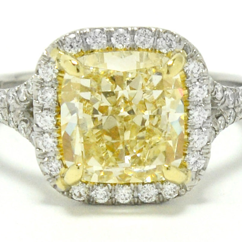 A cushion modified brilliant cut 3 carat yellow canary diamond target ring.