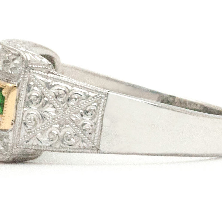 A tapered palladium band with tsavorite and diamonds.