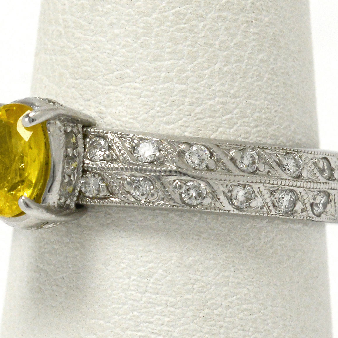 At nearly 1 carat, this golden yellow sapphire is secured by 4 prongs in this band.