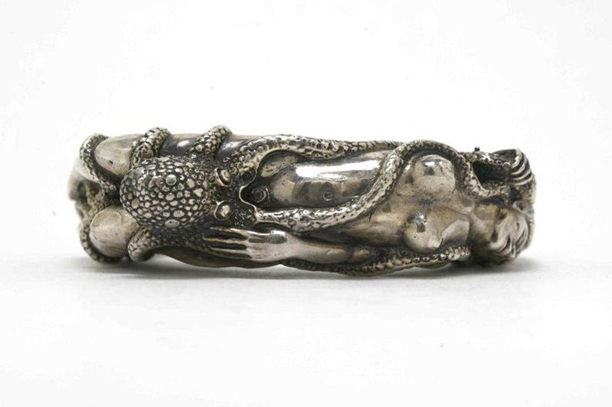 this nude lady silver cuff fits wrists between 6 to 7 inches.