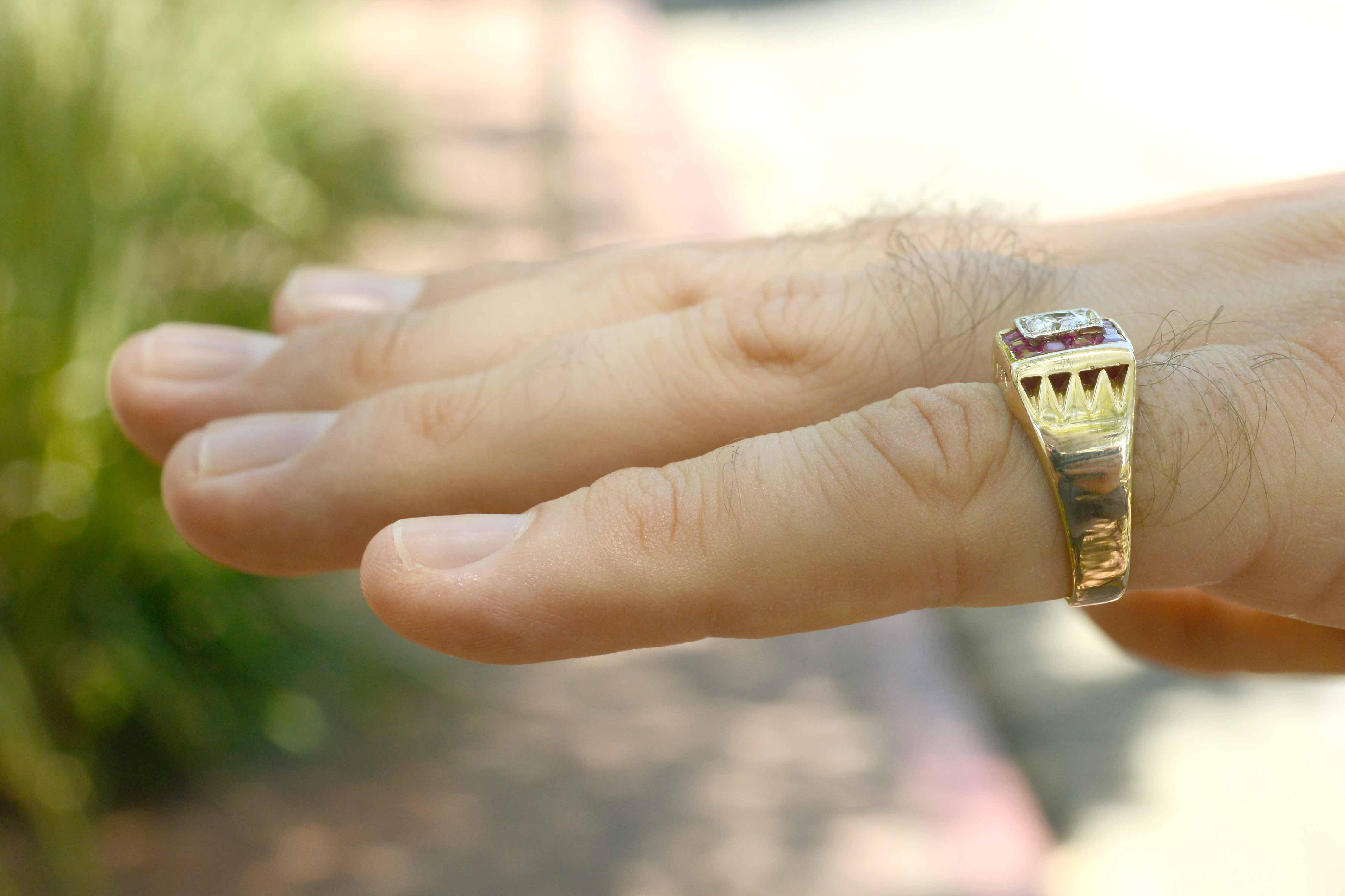 A 2 tone yellow & white gold unisex diamond band with rubies.