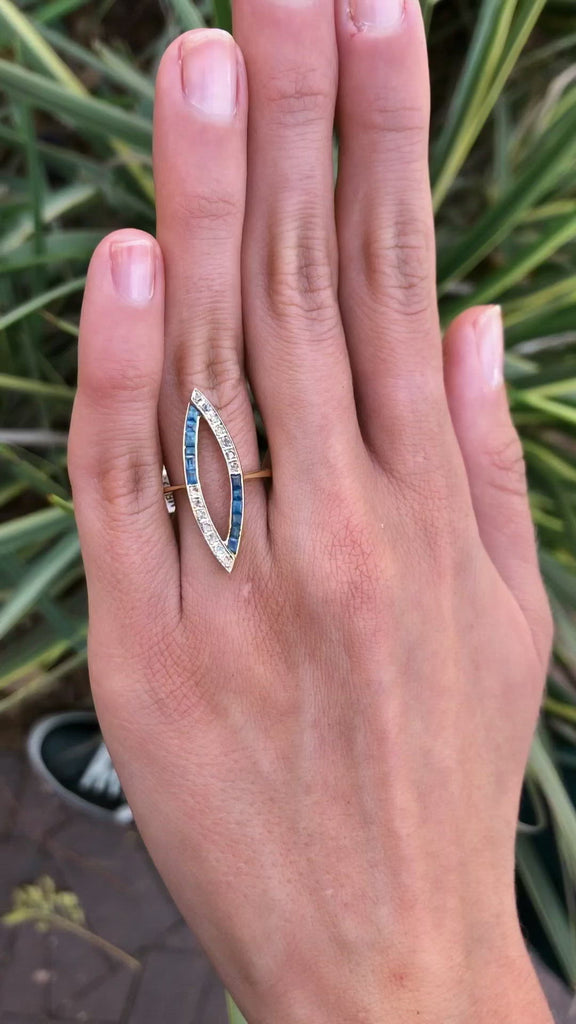 A 2 tone cocktail ring with French cut blue sapphires juxtaposed by rose cut diamonds. 