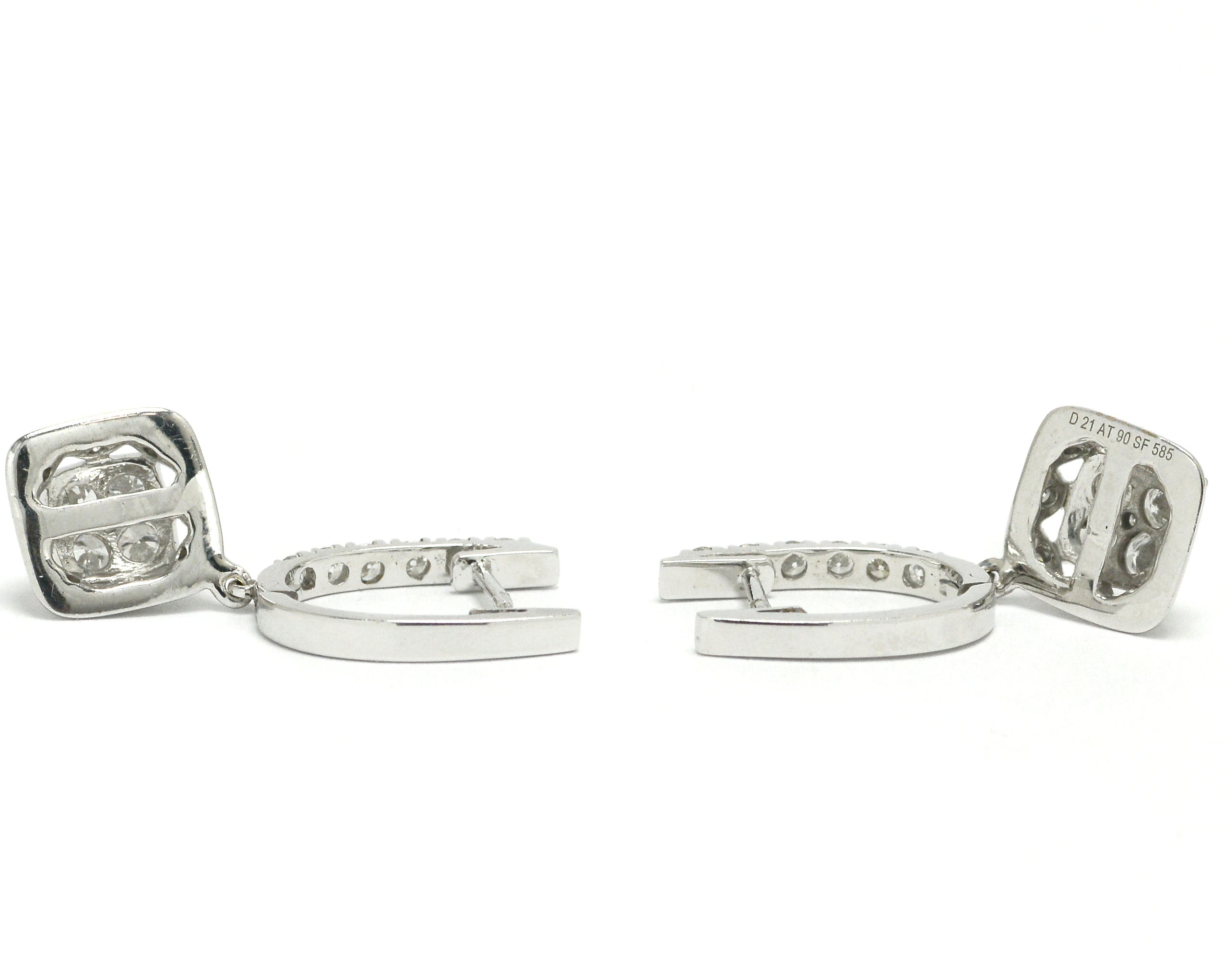 White gold horseshoe latch earrings lined with diamonds.