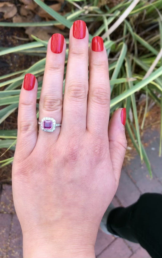 An over one carat square emerald cut pink sapphire engagement ring with diamonds.