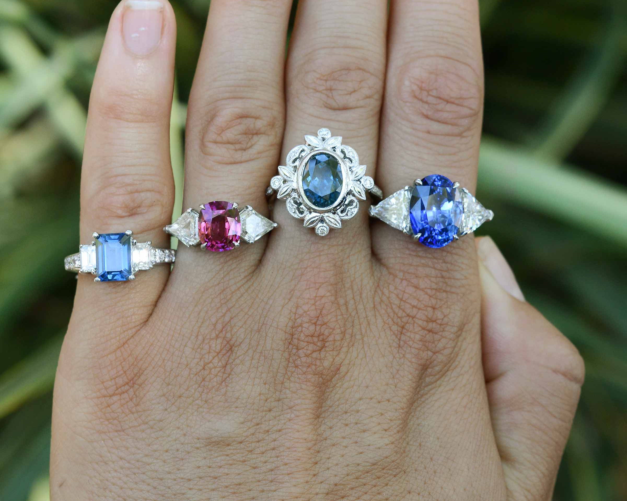 Some of our white gold, sapphire & diamond three stone engagement rings.