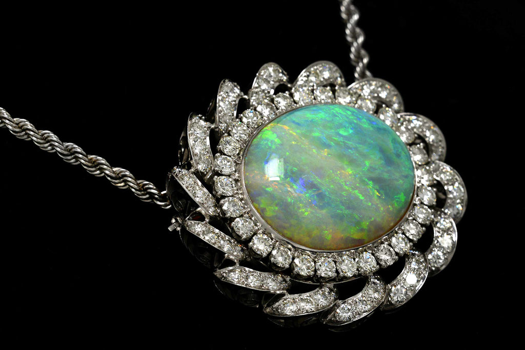 A 30 carat oval cabochon cut opal is set in nearly 10 carats of diamonds.