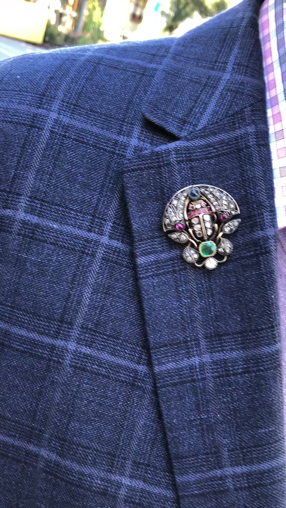 An antique scarab pin that could be worn on a gentleman's suit collar.