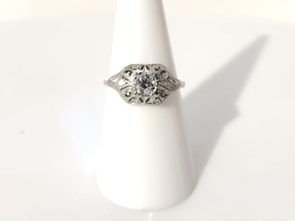 Milgrain lined half carat diamond engagement ring.