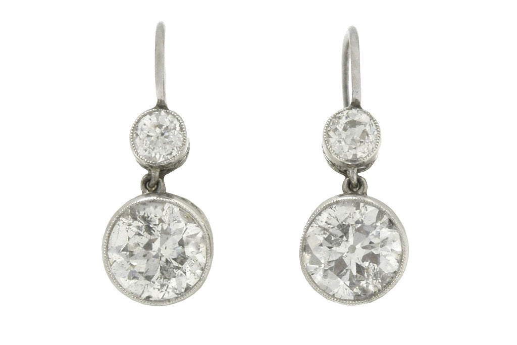 A glimmering pair of Art Deco style diamond drop earrings boasting 4.30 carats of dazzling beauty.
