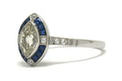 A four point diamond marquise engagement ring with sapphires.