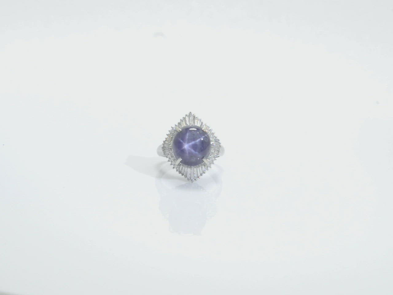 A twenty carat cabochon cut purple star sapphire platinum cocktail ring.
