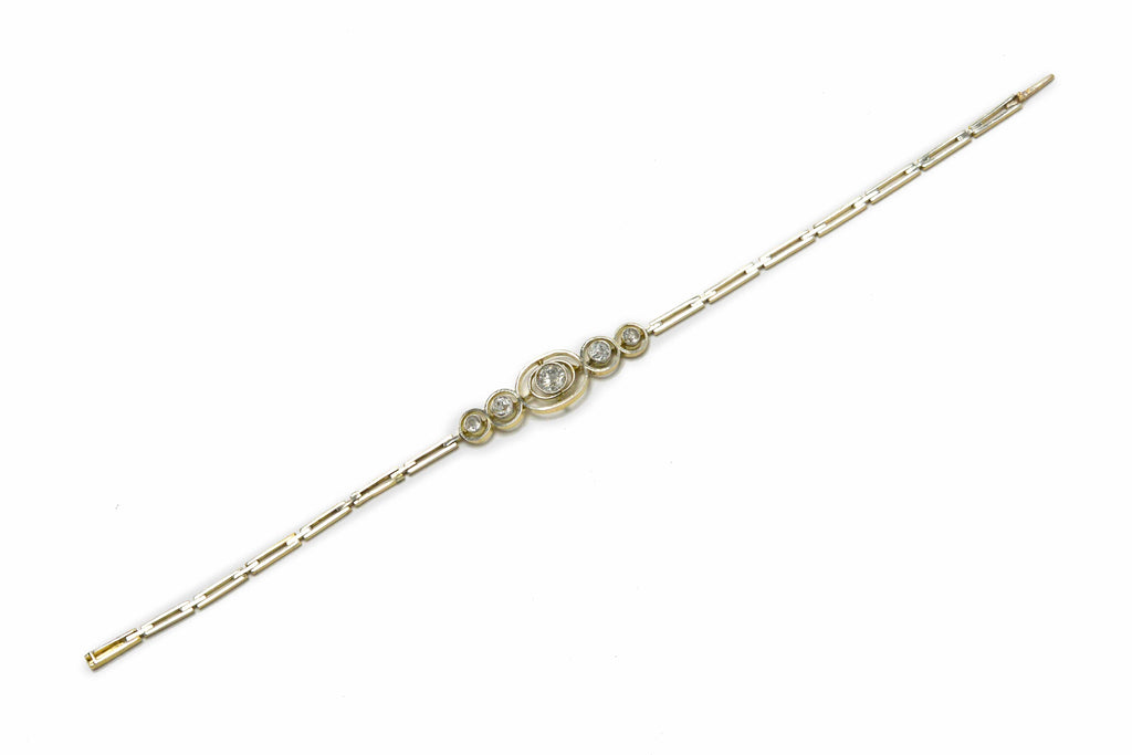 Concentric bezel settings of platinum 5 fiery hand-cut old mine diamonds are set in this bracelet.