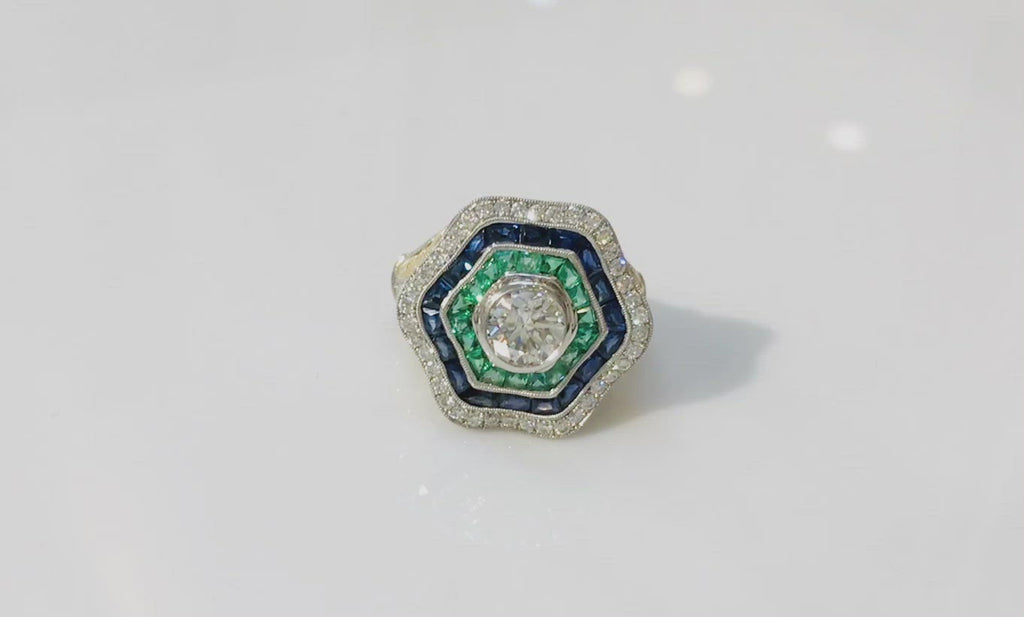 A hexagon round brilliant diamond sapphire ballerina ring.