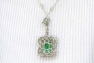 The emerald cut gem of nearly 8 carats glows with a vivid green fire in this white gold pendant necklace.